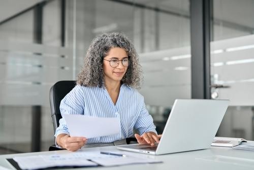 Woman at computer doing work in an office